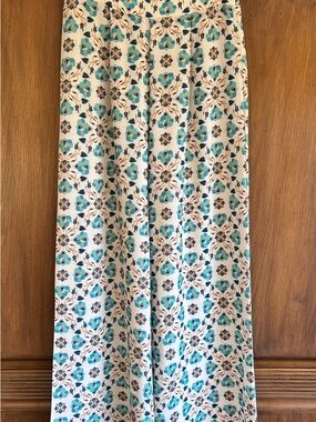 Tasha Pollizi Flowy Pants in Blue and Teal on a Cream Background